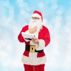 man in costume of santa claus with notepad