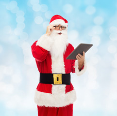 man in costume of santa claus with tablet pc