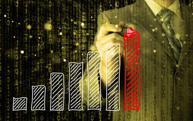 Business man drawing a growing graph