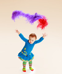 little girl shows up colorful tinsel.