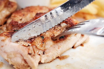 knife cut through the roast chicken
