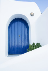 Closed blue door in a greek house