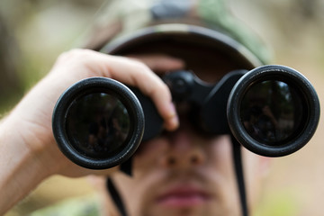 close up of soldier or hunter with binocular