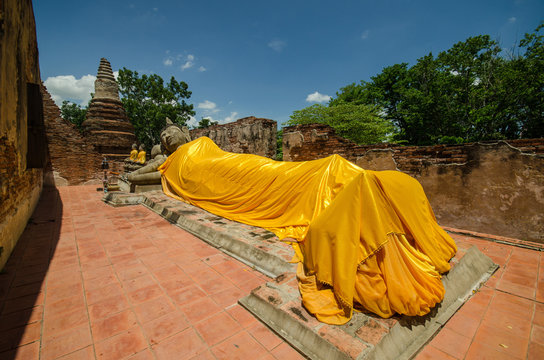 statue at reclining buddha in Wat Puthai Sawam Thailand