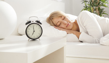 beautiful girl sleeping in her bed. focus on face