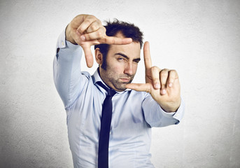 Businessman making a frame with his fingers