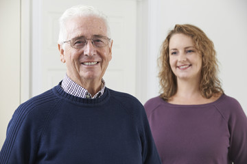 Portrait Of Smiling Senior Man With Adult Daughter
