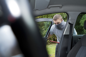 Thief stealing a car