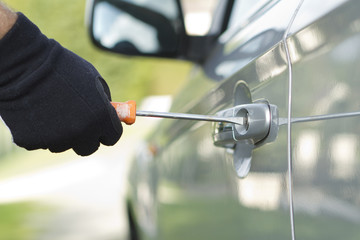 Thief stealing a car