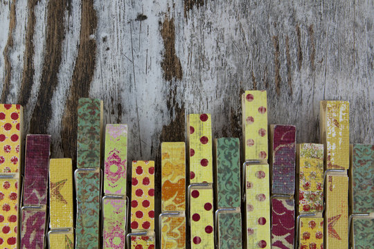 Handmade clothespins in a wood background