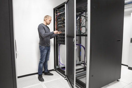 IT consultant building network rack in datacenter