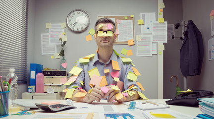 Office worker covered with stick notes