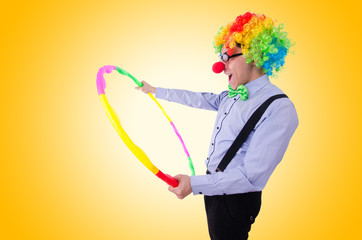 Funny clown with hula hoop on white