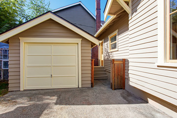 House and garage in clapboard siding trim