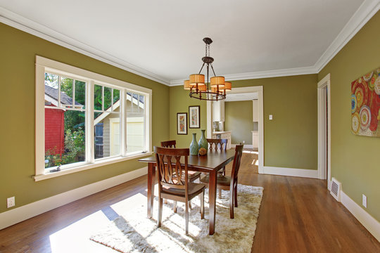 Dining room with olive tone walls