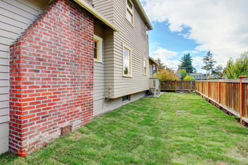 House with brick chimney and fenced backyard