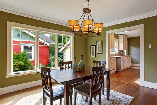 Dining room with olive tone walls