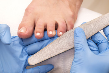 Fototapeta premium process of pedicure at beauty salon