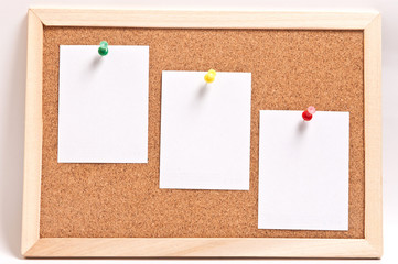 Cork board with blank notes, isolated on white