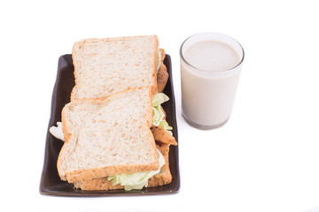 A meal of a sandwich and cold milk