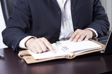 businessman opening his notebook