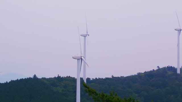 Long panning shot of a Japanese wind mill farm