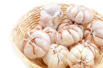 Fresh organic garlic in bamboo basket Isolate on white