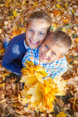 Cute kids with autumn leaves