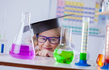 Funny little blonde looks on flasks with reagents