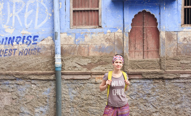 A tourist on a background of a house in the city of Jodhpur. Raj