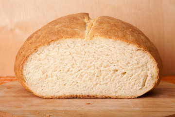 loaf of bread lying on a wooden board