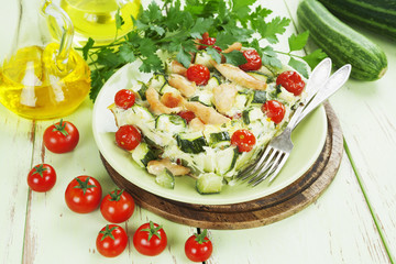 Zucchini baked with chicken, cherry tomatoes and herbs