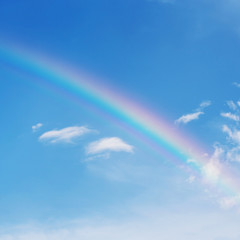 beautiful colorful rainbow on blue sky background