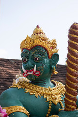 Fototapeta na wymiar Green guardian statue at the Temple of Thailand