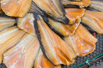 Dried fish on the plastic grid