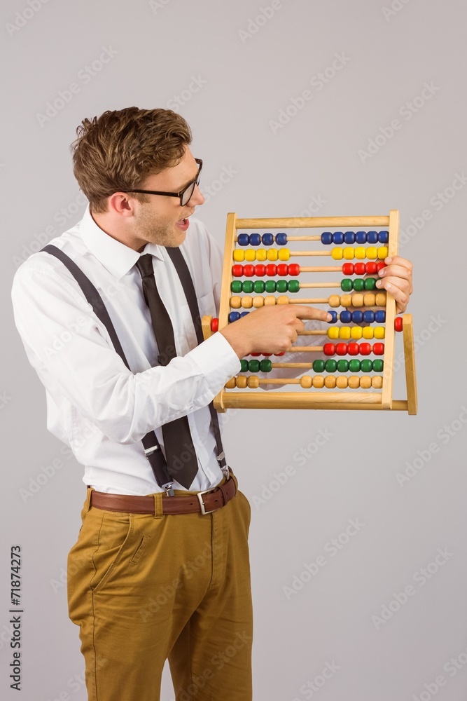 Poster Geeky businessman using an abacus