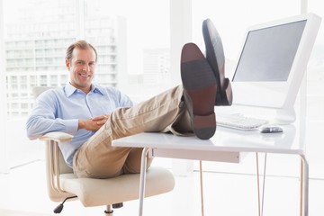 Relaxed businessman with his feet up