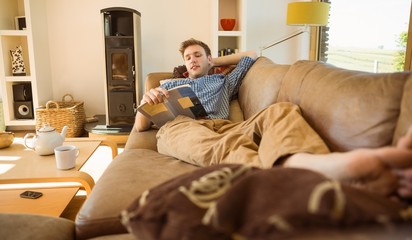 Young man reading on his couch