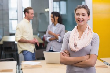 Smiling businesswoman with colleagues in office