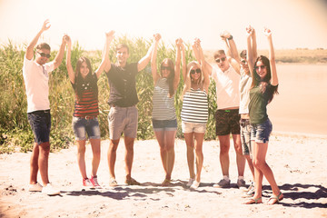 Obraz premium Beautiful young people on beach