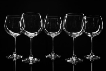 Empty wine glasses isolated on black