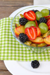 fresh tasty fruit salad on wooden table