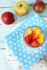 fresh tasty fruit salad on blue wooden table