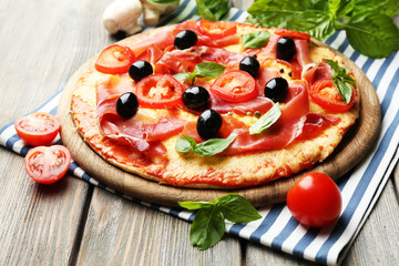 Delicious pizza served on wooden table