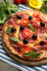 Delicious pizza served on wooden table