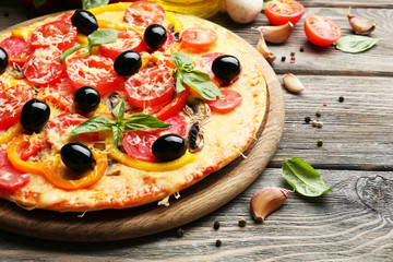 Delicious pizza served on wooden table