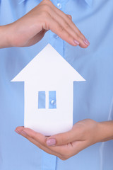 Woman hands holding paper house close up