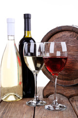 Wine in goblets and in bottles and wooden barrel