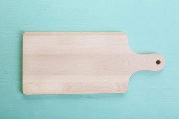 Cutting board on wooden background