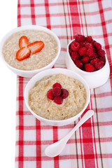 Tasty oatmeal with berries on napkin close-up